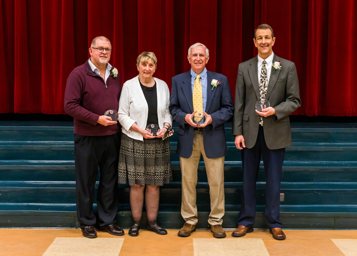 four people standing with their hall of fame awards