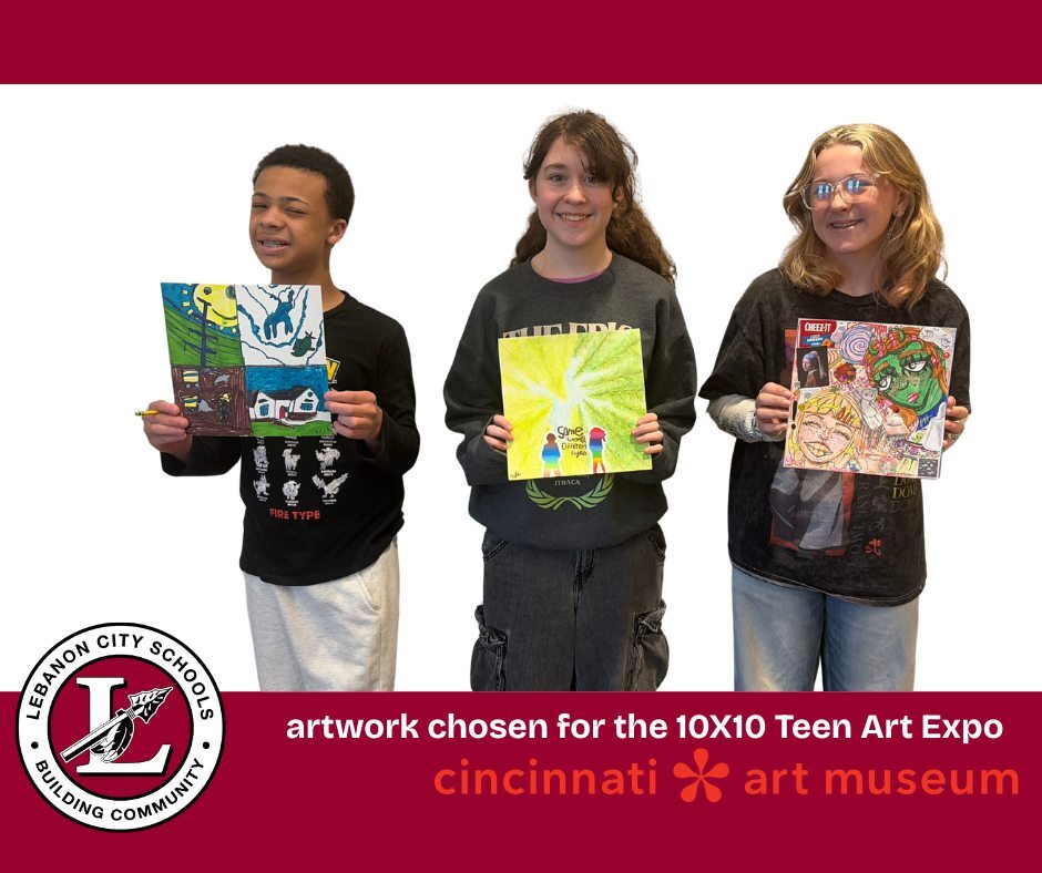 three students holding up their artwork