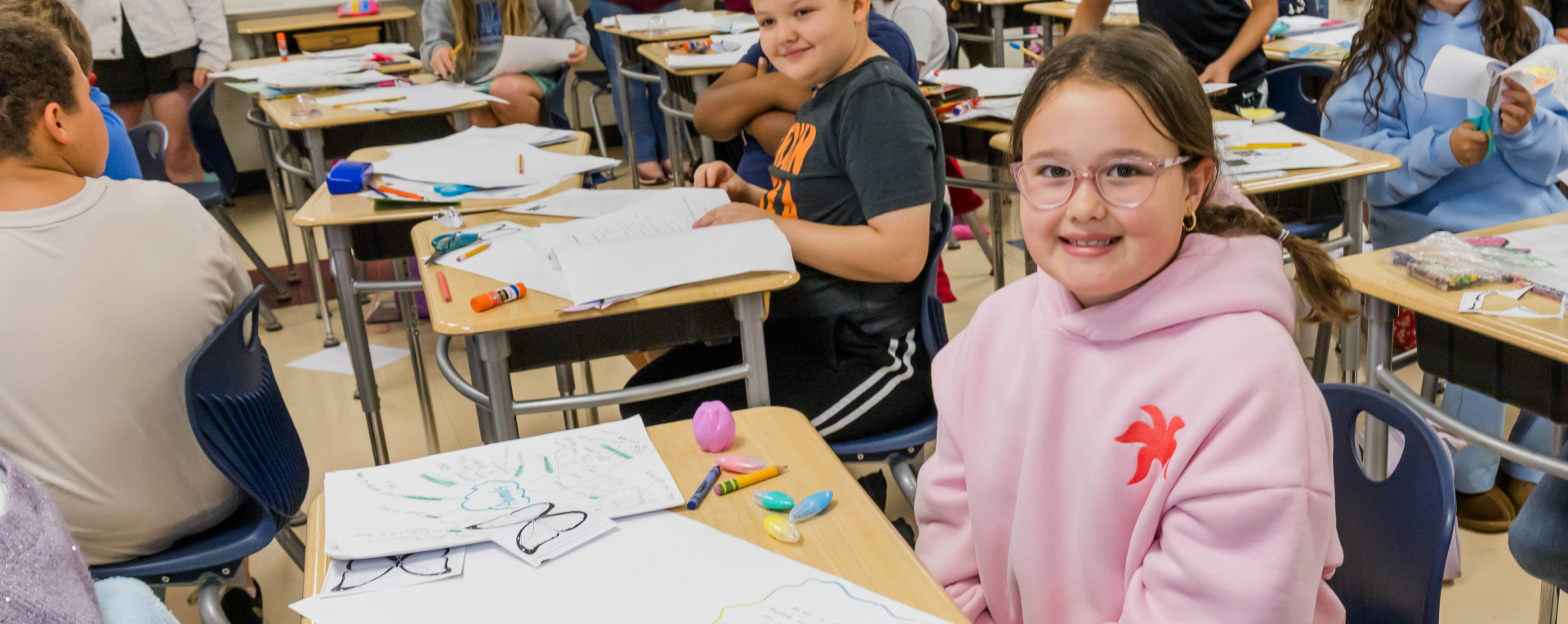 smiling student in a classroom