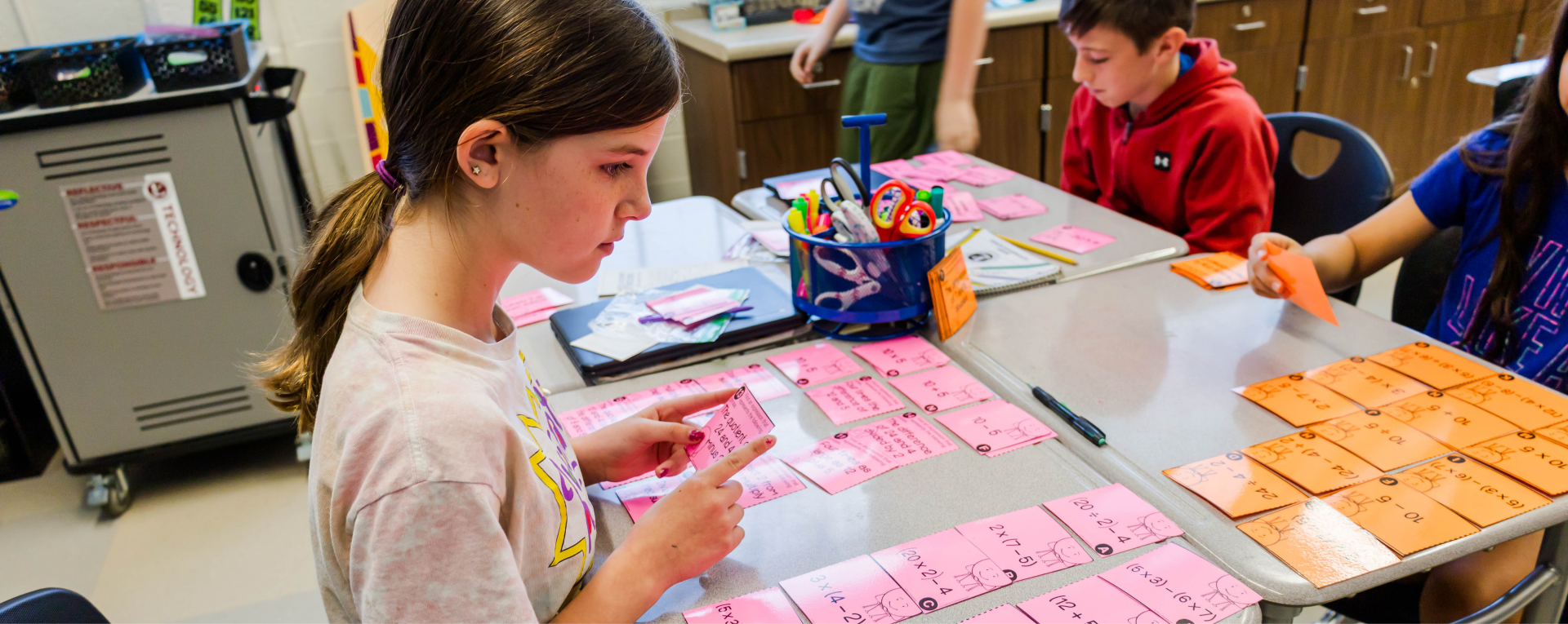 student with colorful cards on a desk