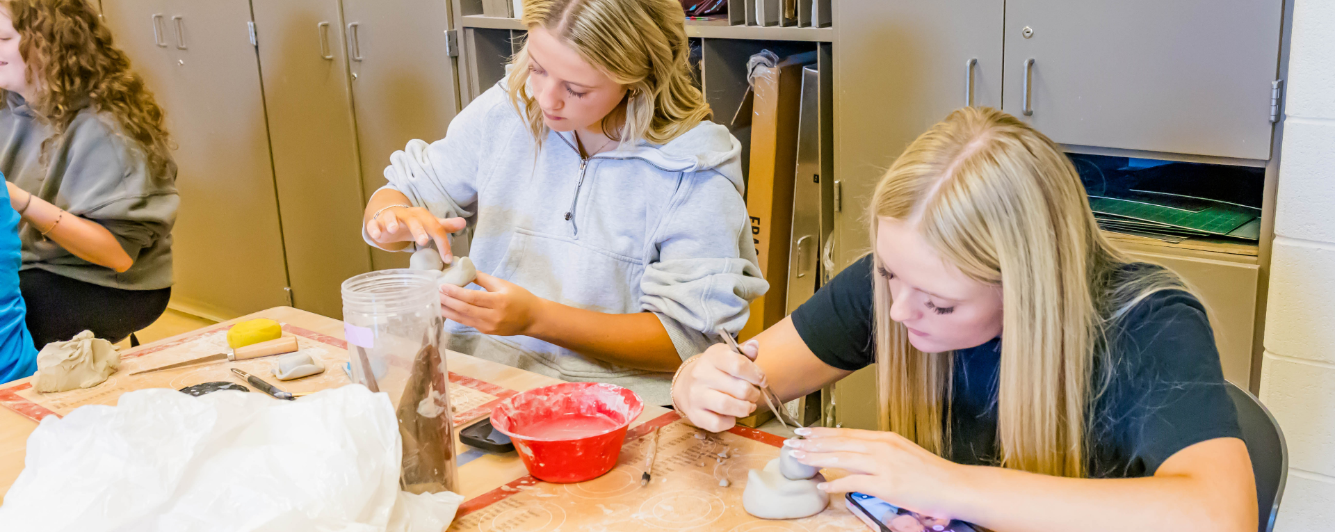 students working with clay